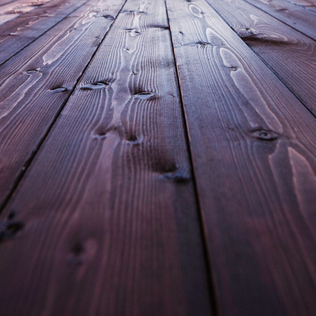 close up of fresh cherry-colored stain on a deck