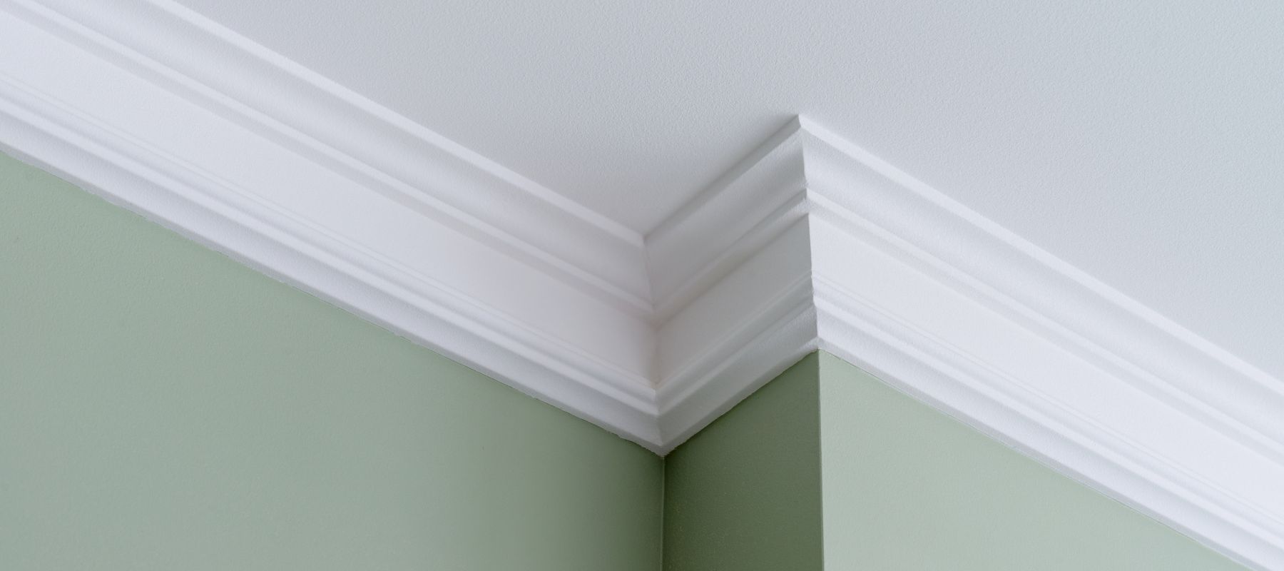 crown molding installed on a green painted wall