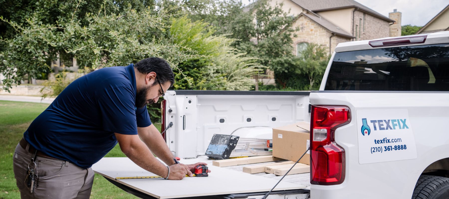 texfix handyman cutting drywall by branded truck