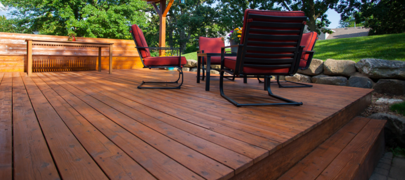 closeup of stained deck with outdoor patio furniture